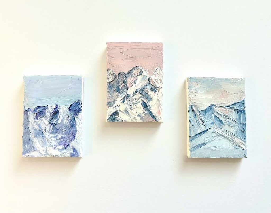three miniature paintings of mountains